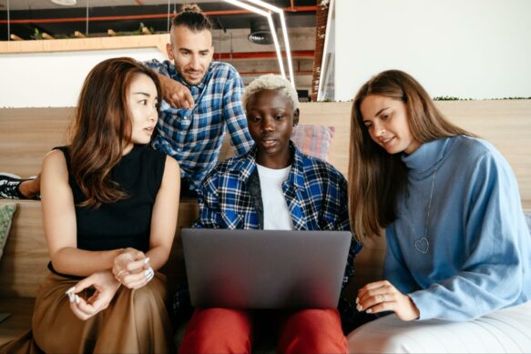 Group of people around laptop