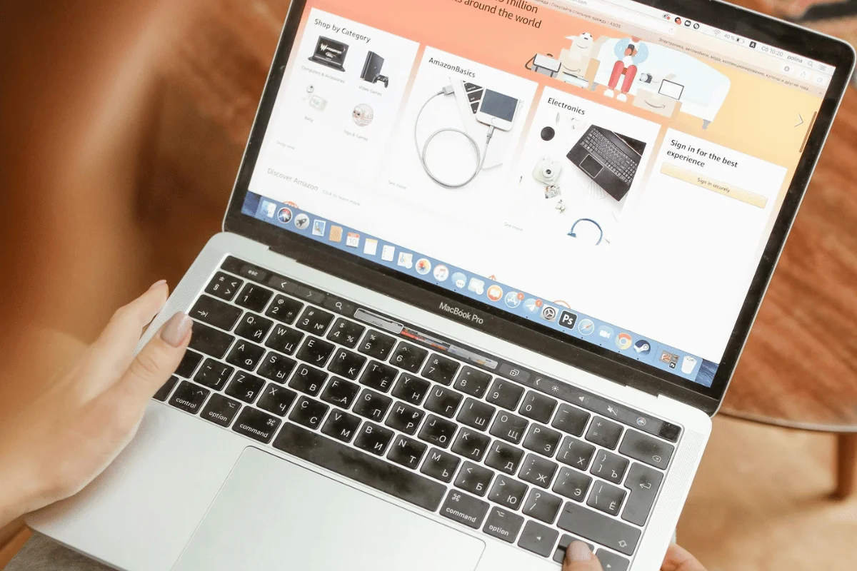 Person browsing Amazon shopping categories on MacBook Pro.