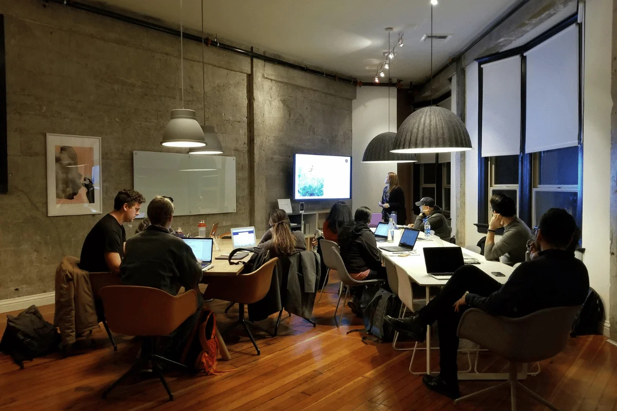 Team attending a business presentation in modern office.