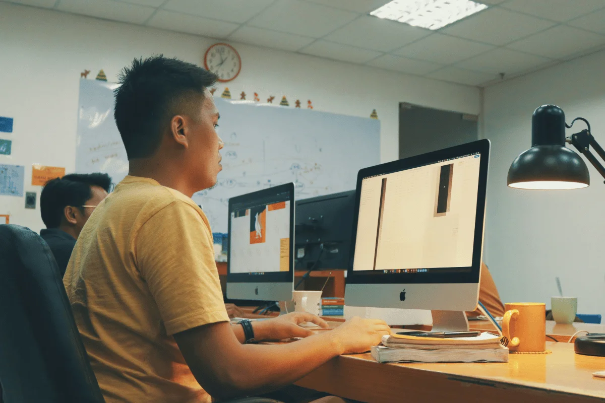 Man working on desktop computer in modern office.