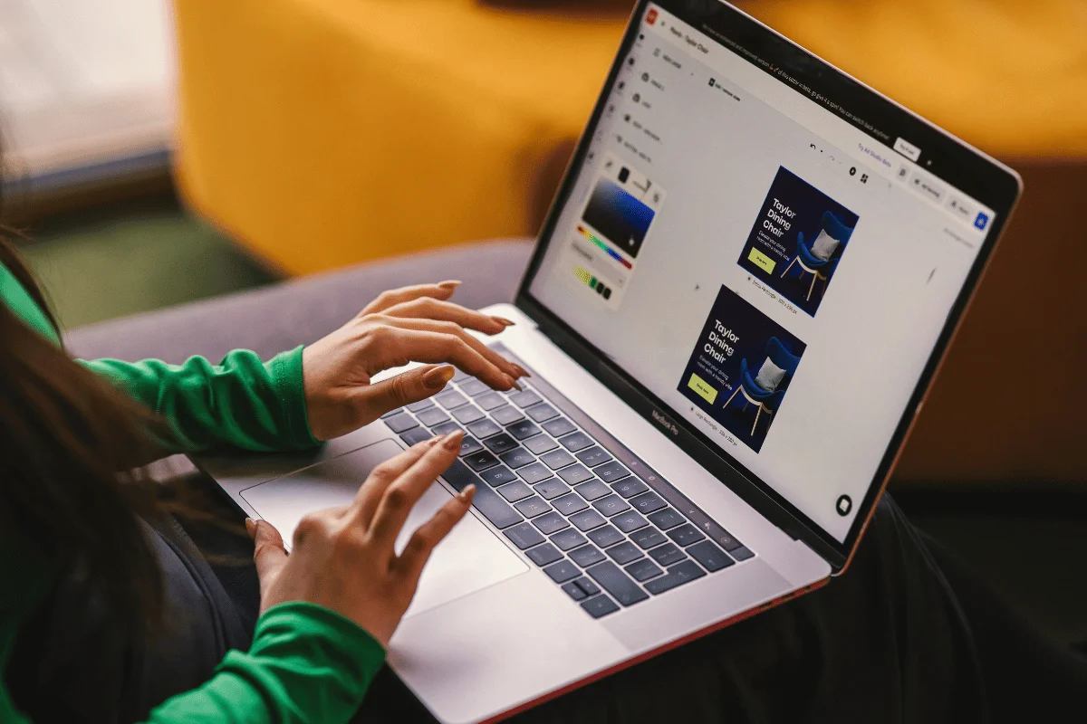Designer creating digital ad mockup on laptop.