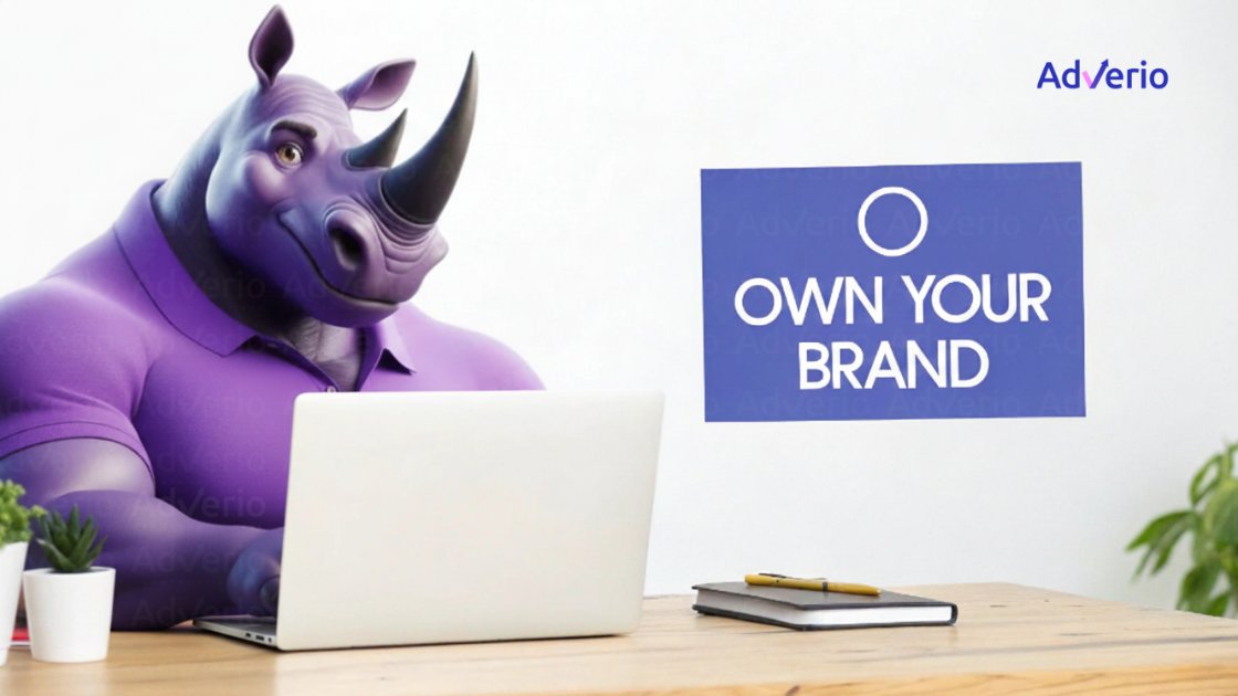 A purple cartoon rhino uses a laptop at a desk, with a sign 'OWN YOUR BRAND' behind it.