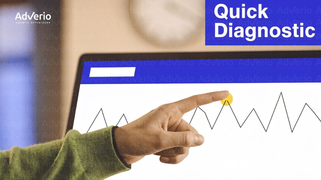 A hand points to a yellow peak on a line graph displayed on a screen with 